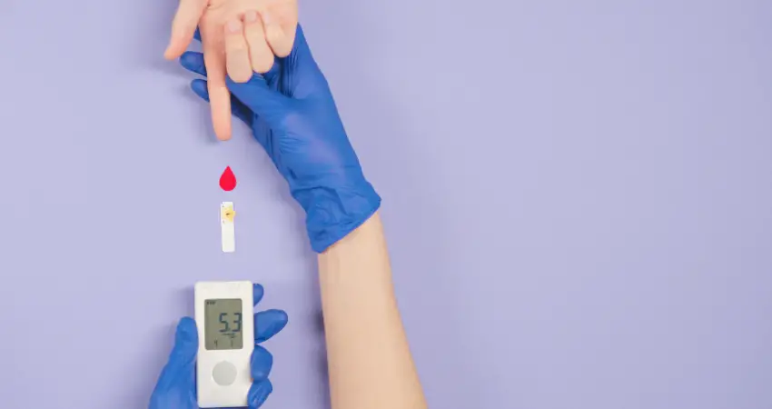 A lady taking her fingerstick for her glucose level.